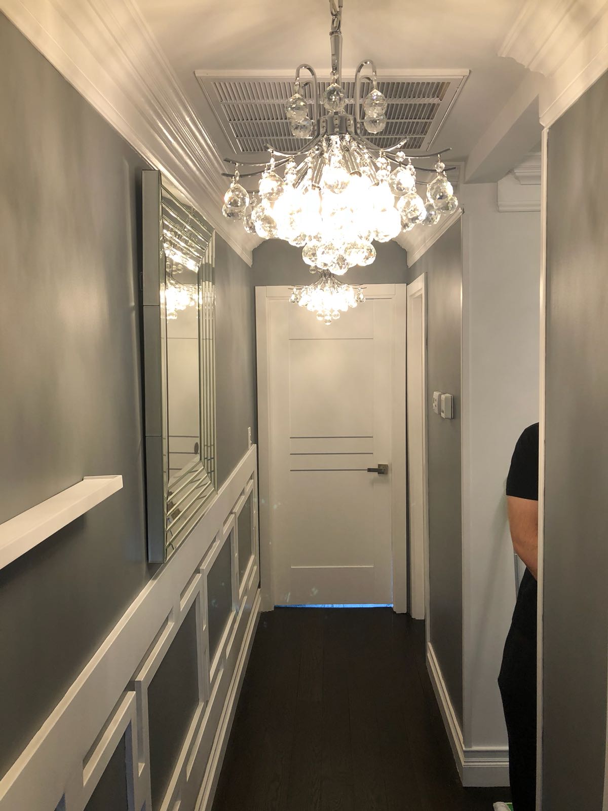 hallway with chandelier